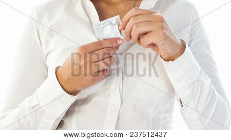 Closeup Isolated Image Of Sexy Young Woman Holding Condom At Her Decolette