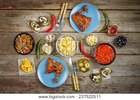 Dinner Table. Various Dishes And Snacks On A Wooden Antique Table With Chicken Barbecue And Lager Be
