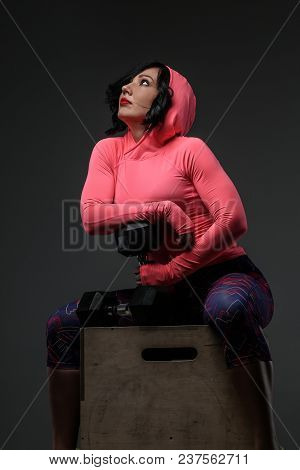 Attractive Fitness Woman In Sportswear Posing With Dumbells In Sudio On Grey Background