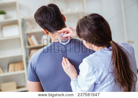 Doctor checking patients joint flexibility with gonimeter