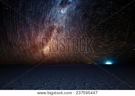 Salar de Uyuni salt flat and night starry sky. Stars processed with trails like a comets. Altiplano, Bolivia