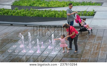 Bangkok, Thailand - April 22: An Unidentified Family Enjoys A Day Out With The Water Fountains In Me