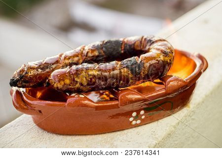 Traditional Portuguese Chourico Or Spanish Chorizo Prepared In A Special Clay Pot