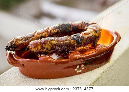 Traditional Portuguese Chourico Or Spanish Chorizo Prepared In A Special Clay Pot