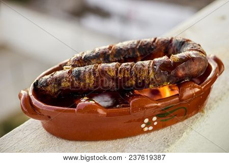 Traditional Portuguese Chourico Or Spanish Chorizo Prepared In A Special Clay Pot