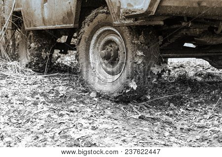 Dirty Wheels Of Off-road Car On Natural Background