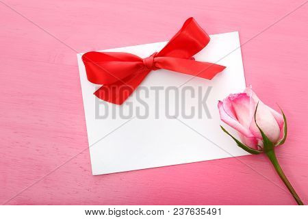 Rose With Greeting Card On A Pink Background