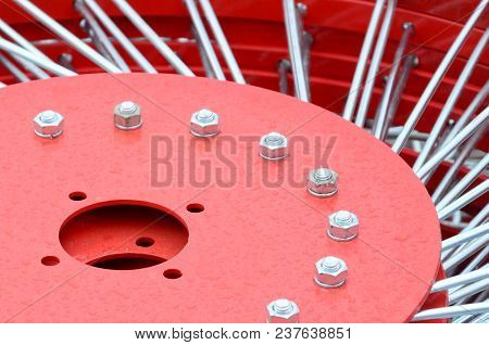 New Red Tedder For Trailer In Agricultural Machinery For Gathering Hay. Close Up