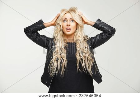 Startled Blonde Raising His Eyebrows And Opening His Mouth Falling Into A Panic Worrying To Hear Bad