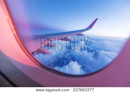 Sunset sky with beautiful clouds from the airplane window