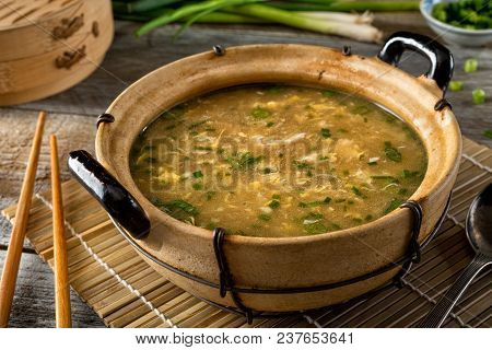 A Bowl Of Delicious Egg Drop Soup With Green Onion Garnish.