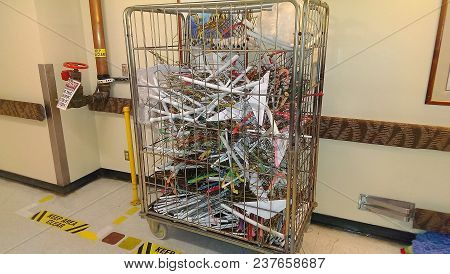 Large Wire Laundry Bin Filled With Wire Hangers Parked In Dry Standpipe Area Marked 