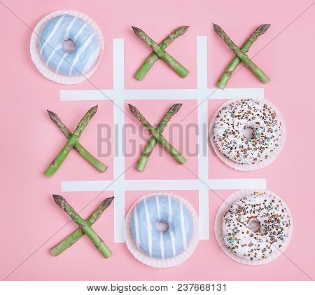 Tik Tak Toe Game With Donuts And Asparagus. Health Nutrition Concept Image