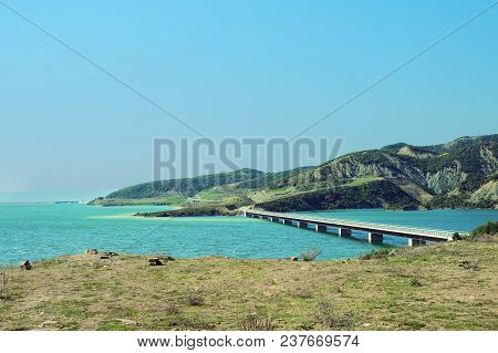 Landscape With Mountains, Forest And A River In Front With A Long Bridge. Beautiful Scenery Of The N