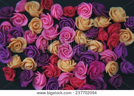 Mix Of Pink And Peach Fake Plastic Mini Rosess Flowers Black Background Copy Space. Craft, Art,