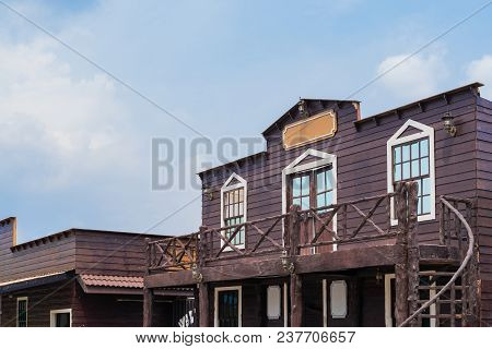 Building Ventage Cowboy Style On Blue Sky Background, Classic City Concept.
