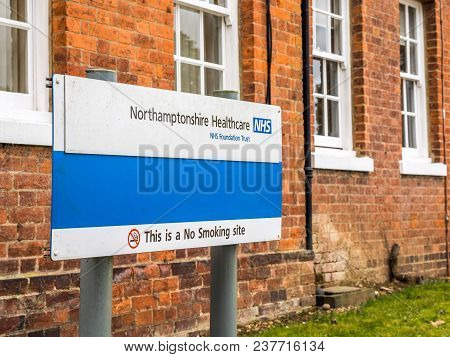 Daventry, Uk March 23 2018: Northamptonshire Healthcare Nhs Foundation Trust Sign Post With Warning 