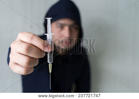Bad Guy. Addict Man With Syringe Using Drugs. Drug Addict Boy Holding Syringe With Drugs.