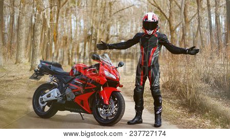 Krasnoyarsk, Russia - April 21, 2018: Beautiful Motorcyclist In Full Gear And Helmet On A Red And Bl