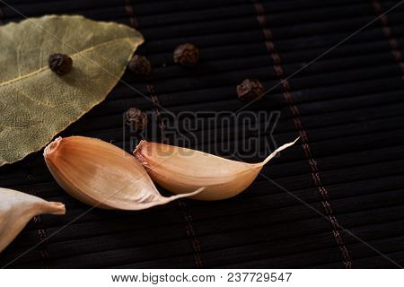 Garlic, Bay Leaf On A Style Black Wooden Background