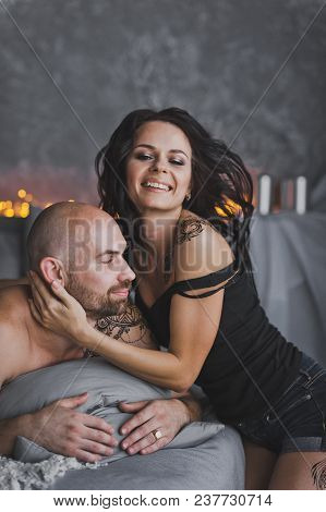 Girl Gently Hugs The Neck, A Bald Beefy Man.