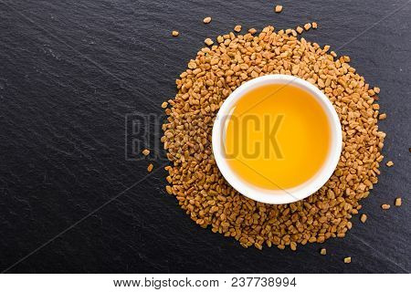 Fragrant Grains Of Fenugreek On A Rustic Background.