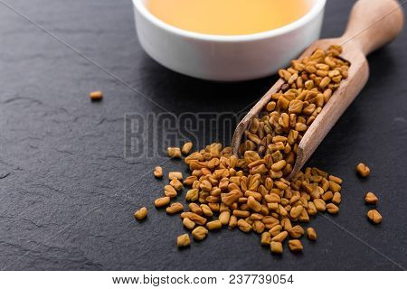 Fragrant Grains Of Fenugreek On A Rustic Background.