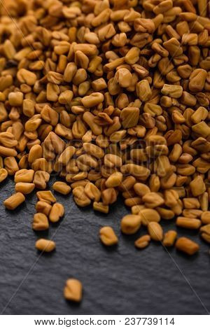Fragrant Grains Of Fenugreek On A Rustic Background.