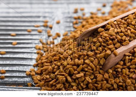 Fragrant Grains Of Fenugreek On A Rustic Background.