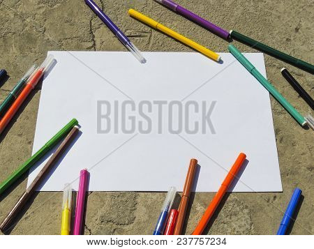 White Sheet Of Paper With Markers. View From Above