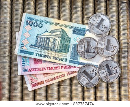 Silver Crypto Coins Litecoin Ltc, Paper Denominations Belarusian Ruble. Metal Coins Are Laid Out In 