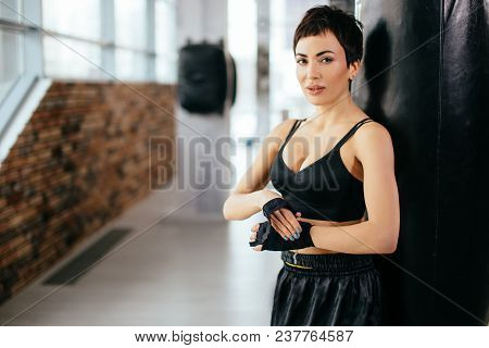 Young Caucasian Female Fixing Bandage At Sport Centure. Tight Bandage. Wrap Infirm Hand.