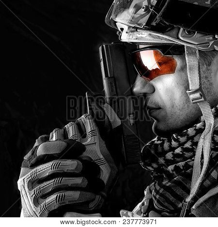 Macro View Of Military Man With Gun