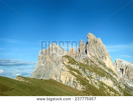 Amazing Views In The Dolomites Mountains. Seceda. Man On The Edge Of The Cliff.