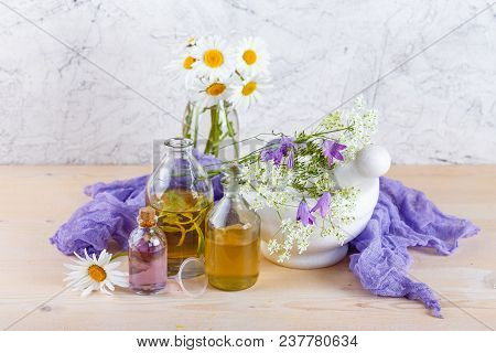 Bottles With Natural Aroma Of Essential Oils, Mortar And Wild Flowers, Spa Concept.