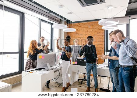 Diverse Partners Are Holding A Jubilee Over A Victory In The Office Room