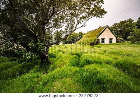 Amazing view of turf church Hofskirkja. Location place of Iceland, small village Hof, Europe. Scenic image of beautiful nature landscape. Attractive summer scene. Discover the beauty of earth.