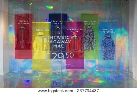 Bracknell, England - April 12, 2018: Colorful Window Display Of Rain Macs And Shower Proof Coats In 