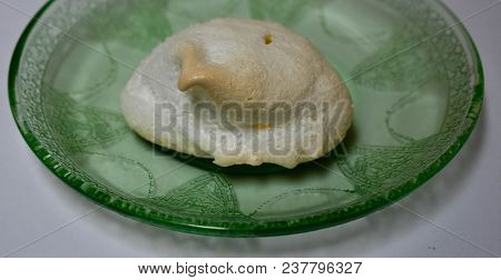 Meringue On A Green Vaseline Glass Plate.