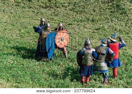 Luh, Russia - August 27, 2016: Reconstruction Of Medieval Battle Of Knights In Armor And Weapons At 