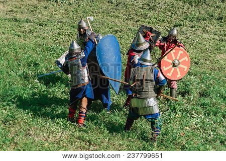 Luh, Russia - August 27, 2016: Reconstruction Of Medieval Battle Of Knights In Armor And Weapons At 