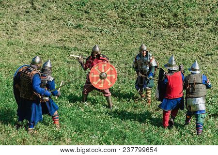 Luh, Russia - August 27, 2016: Reconstruction Of Medieval Battle Of Knights In Armor And Weapons At 