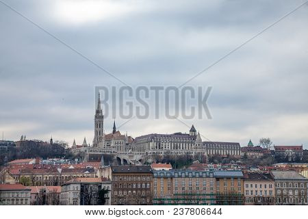Buda Castle Seen From Pest With The Matthias Church In Front.  The Cast Is The Historical Palace Com