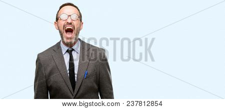 Teacher man using glasses stressful, terrified in panic, shouting exasperated and frustrated. Unpleasant gesture. Annoying work drives me crazy isolated over blue background