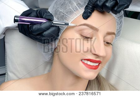 Microblading. Cosmetologist Making Permanent Makeup. Attractive Woman Getting Facial Care And Tattoo