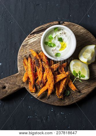 Crispy Cornmeal Sweet Potato Fries Rustic Wooden Cutting Board On Dark Background, Top View