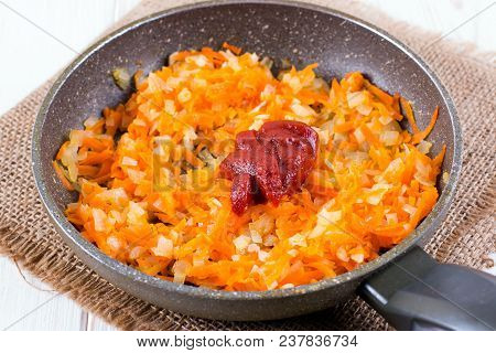 Tomato Onion Carrot And Tomato Paste In A Pan On A White Background