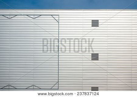 Empty Blank Steel Billboard Frame On Facade Of Industial Style Building