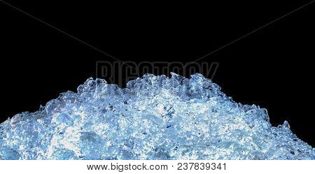 Pile Of Crushed Ice Cubes On Dark Background With Copy Space. Crushed Ice Cubes Foreground For Bever