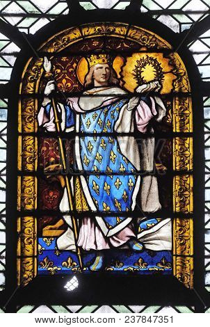 PARIS, FRANCE - JANUARY 04: Saint Louis, stained glass window in the Saint Sulpice Church, Paris, France on January 04, 2018.